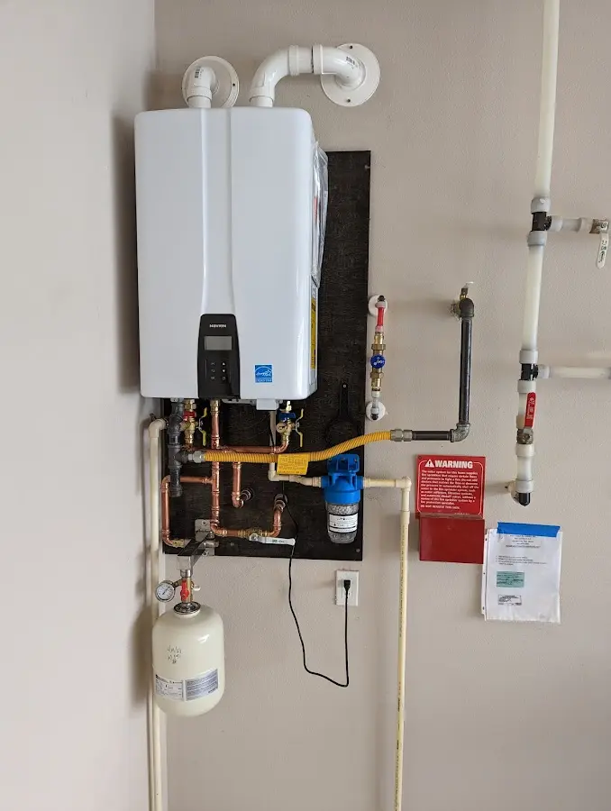 Professional plumber installing copper piping in a Shaker Heights home